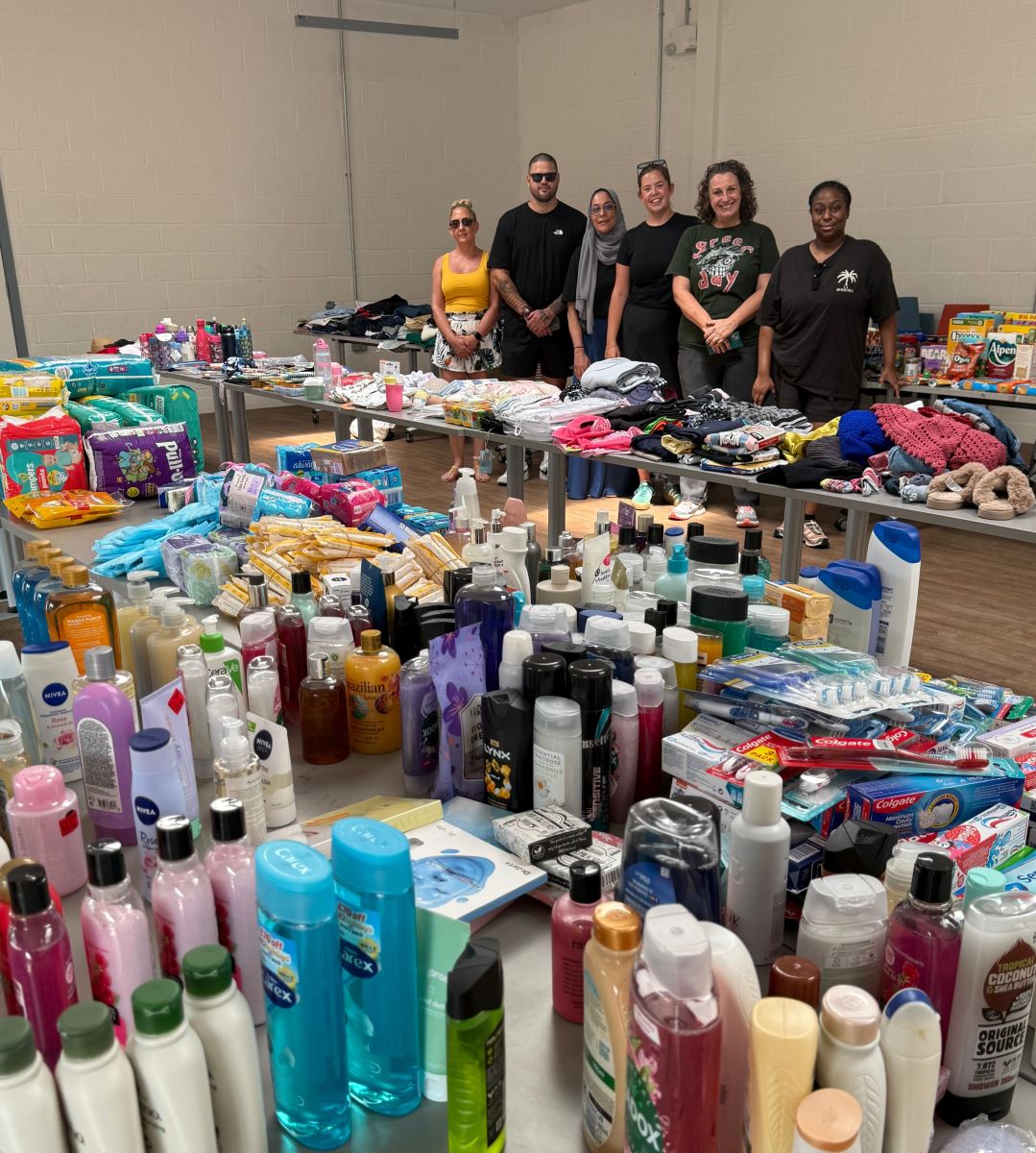 Group standing next to donations